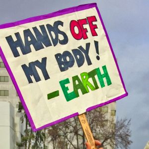 Women's March Oakland sign "Hands off my body!- Earth"